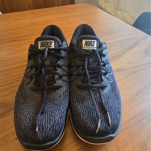 Nike Black Athletic Shoes with Mesh Upper and Sleek Design